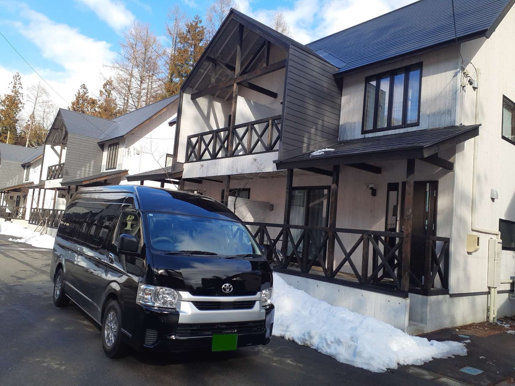 9-seat private minibus pickup near a Hakuba winter chalet