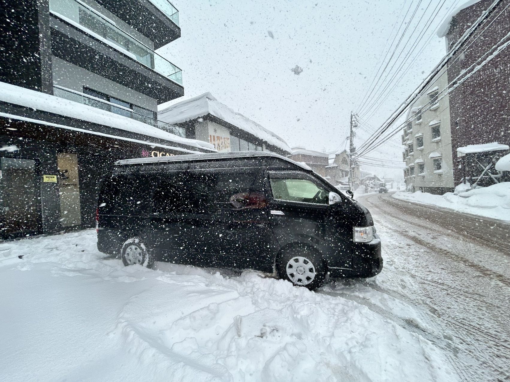 Private 9-seat minibus serving Hakuba village during heavy snowfall