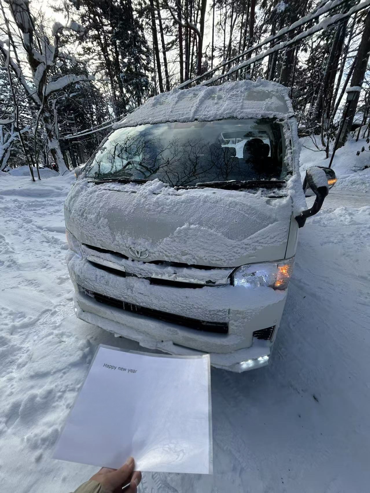 Private 9-seat minibus prepared for a winter passenger pickup in Hakuba